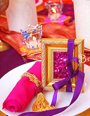 small party table decorations and rolled like percian carpet napkins decorated with ribbons and golden tassels for party table decorating ideas in moroccan style