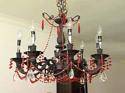black chandelier with red beads and large crystals in baroque period interior decorating style
