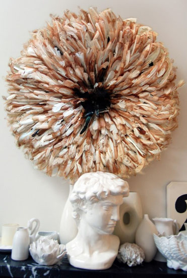juju hat made of brown and white bird feathers used for modern wall decor