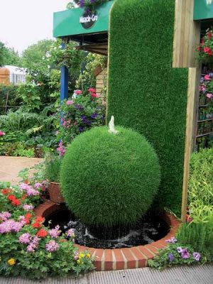 green bush and garden fountain design is one of creative backyard ideas