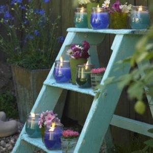 garden decorations candle holders on shelves made of old wooden ladder