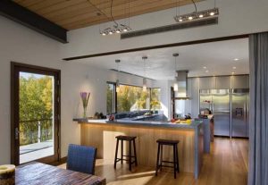 modern kitchen design with wood cabinets and dining furniture