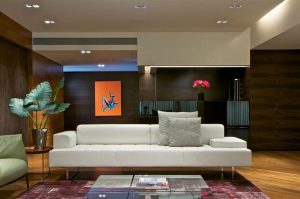 white sofa and wood wall paneling