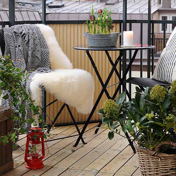 traditional lantern and warm throw for balcony decorating in swedish style