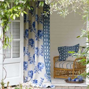 white and blue curtains and decorative pillows