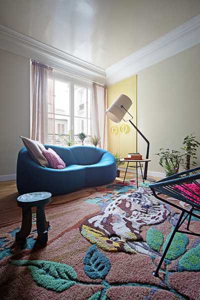 living room sofa in blue color and sculptured floor rug