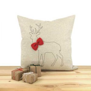 reindeer and red bow on white pillow