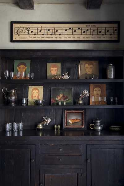 dining room shelves with antique portraits