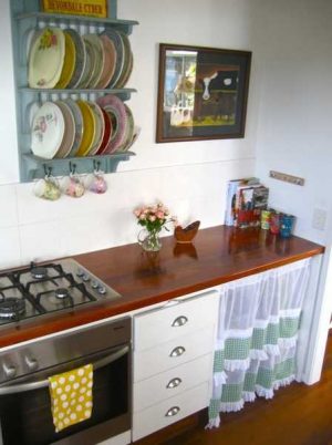 vintage style wall shelves and kitchen cabinet with curtain