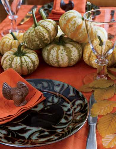 individual table centerpieces with chocolate turkey and orange napkins