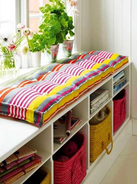 white bench with storage and colorful cushion