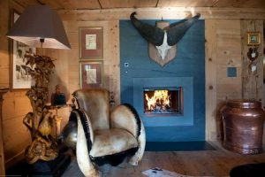 blue fireplace and unique lamp and chair decorated with fur