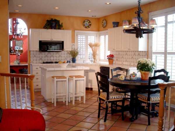 white kitchen cabinets, ceramic floor tiles and yellow paint for walls