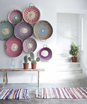 white wall decorating with colorful wicker bowls