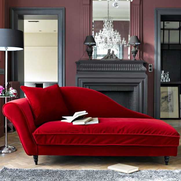 red recamier for living room decorating with fireplace, large wall mirror and crystal chandelier