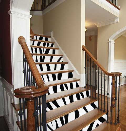 wooden stairs with black and white stripes