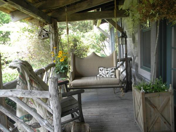 porche decorating with rustic wood and hanging swing bench