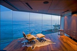 eames lounge chair in room with glass wall