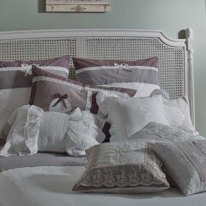 luxurious bedding set wih decorative pillows and lace