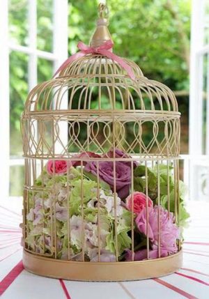 table decoration with flowers and birdcages
